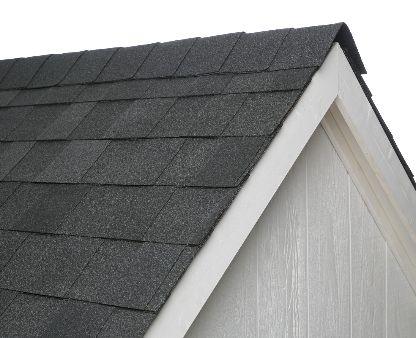 Close-up of an Atlas Pinnacle Pristine Black Shadow roofline against white trim and white siding