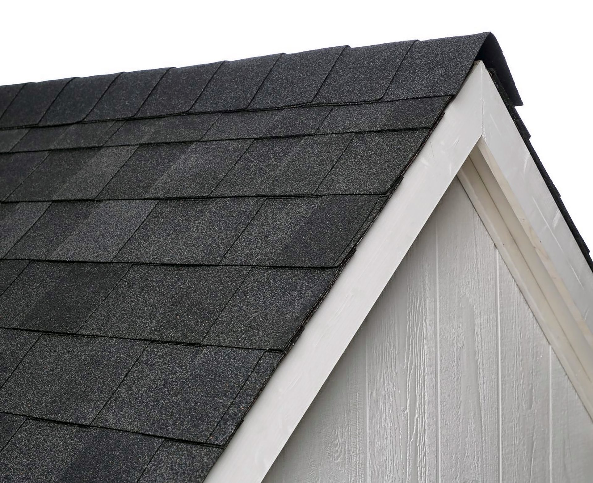 Close-up of an Atlas Pinnacle Pristine Black Shadow roofline against white trim and white siding