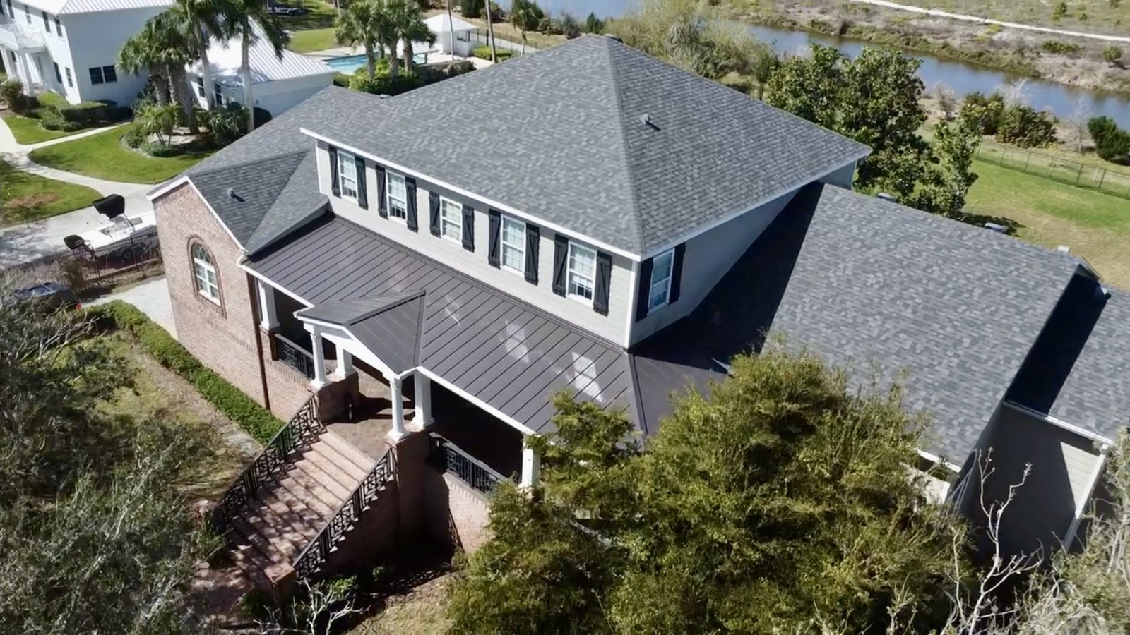 Aerial view of a completed shingle and standing-seam metal roof replacement