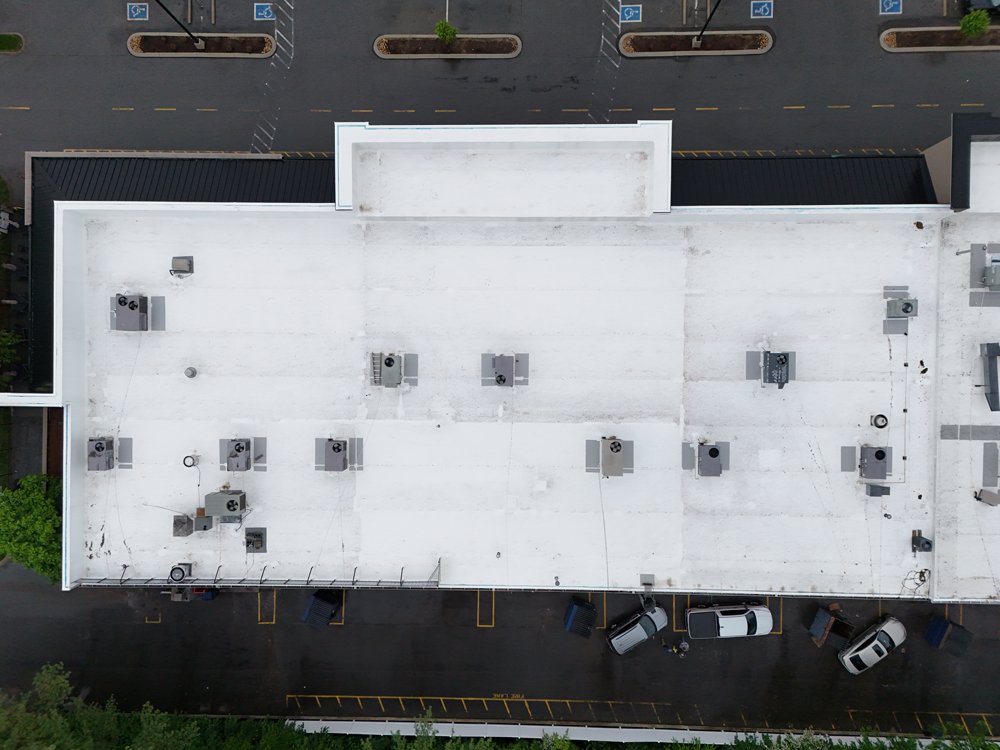 Overhead view of a commercial building with a white Carlisle PVC roof