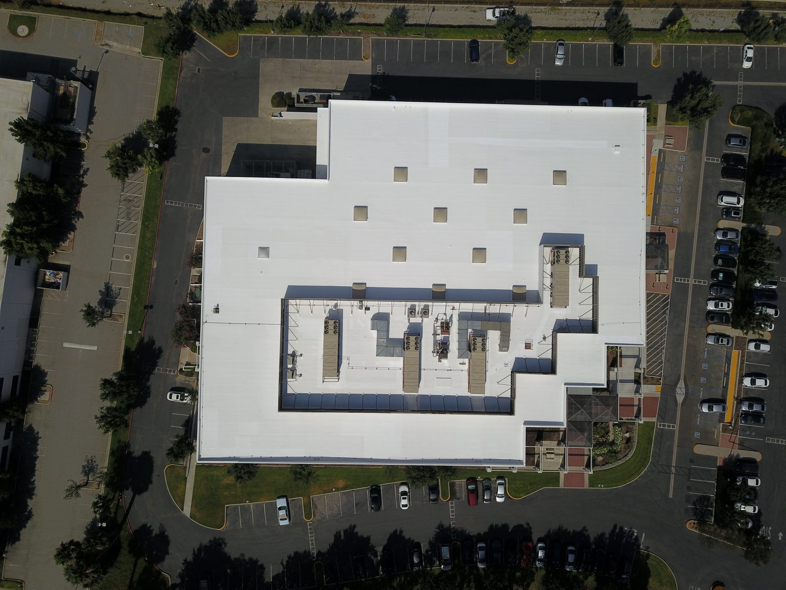 Completed silicone roof coating restoration on a commercial building
