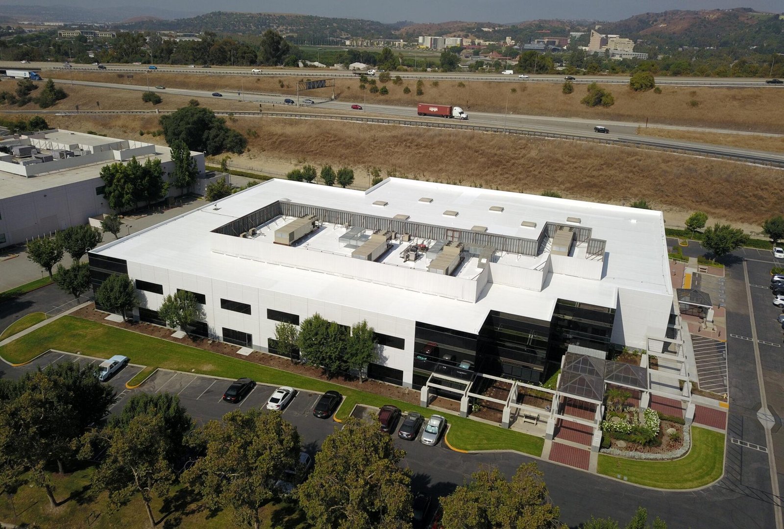 Commercial office building with a completed white flat roof membrane