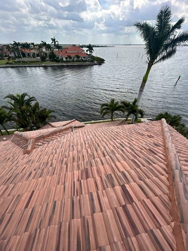 Crown concrete tile roof overlooking a bay with palm trees