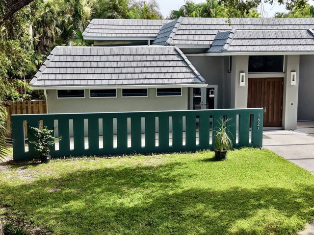 Drone view of a gray concrete tile hip roof